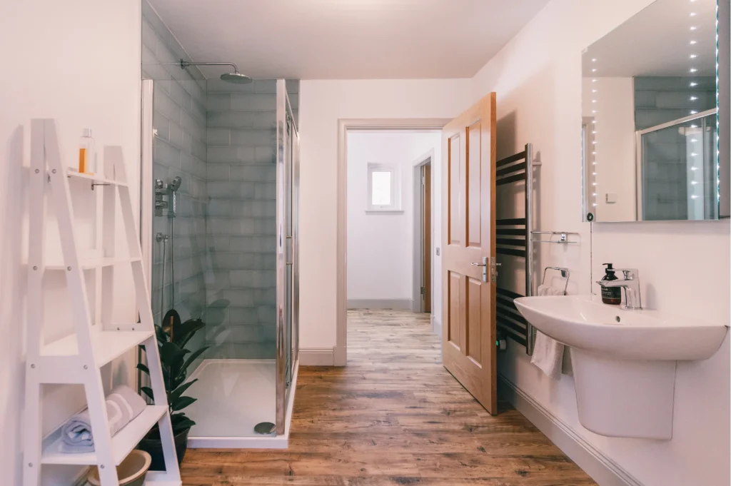 An Dòbhran ground floor bathroom with easy accessible walk-in shower, with rain and hand-held shower, Highland Soap Company toiletries and White Company towels